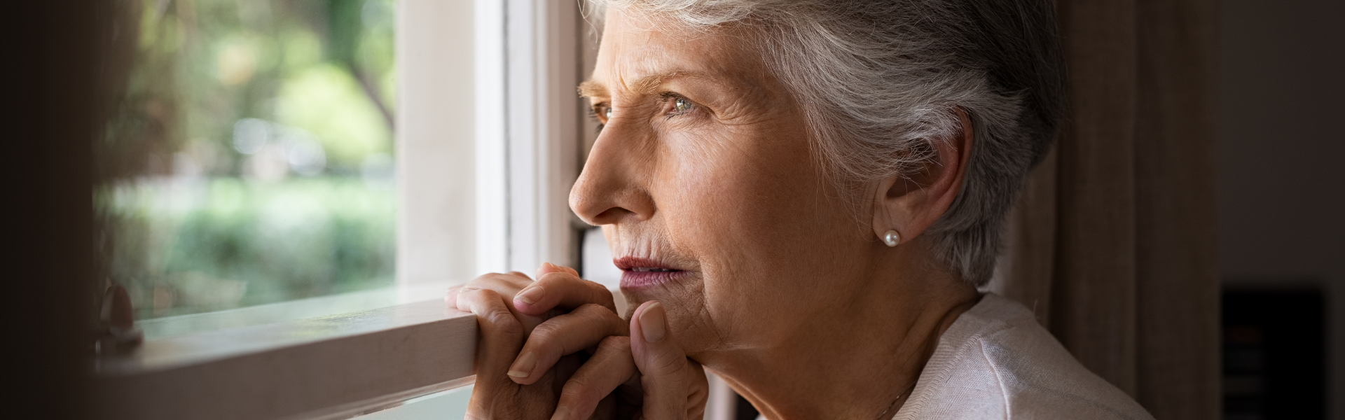 Image of woman looking out a window